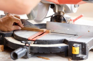 Home Repair - carpenter cut wood for house construction