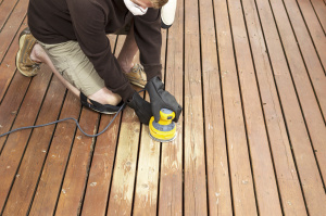 Exterior Carpentry- repairing wood rot in deck by sanding & staining